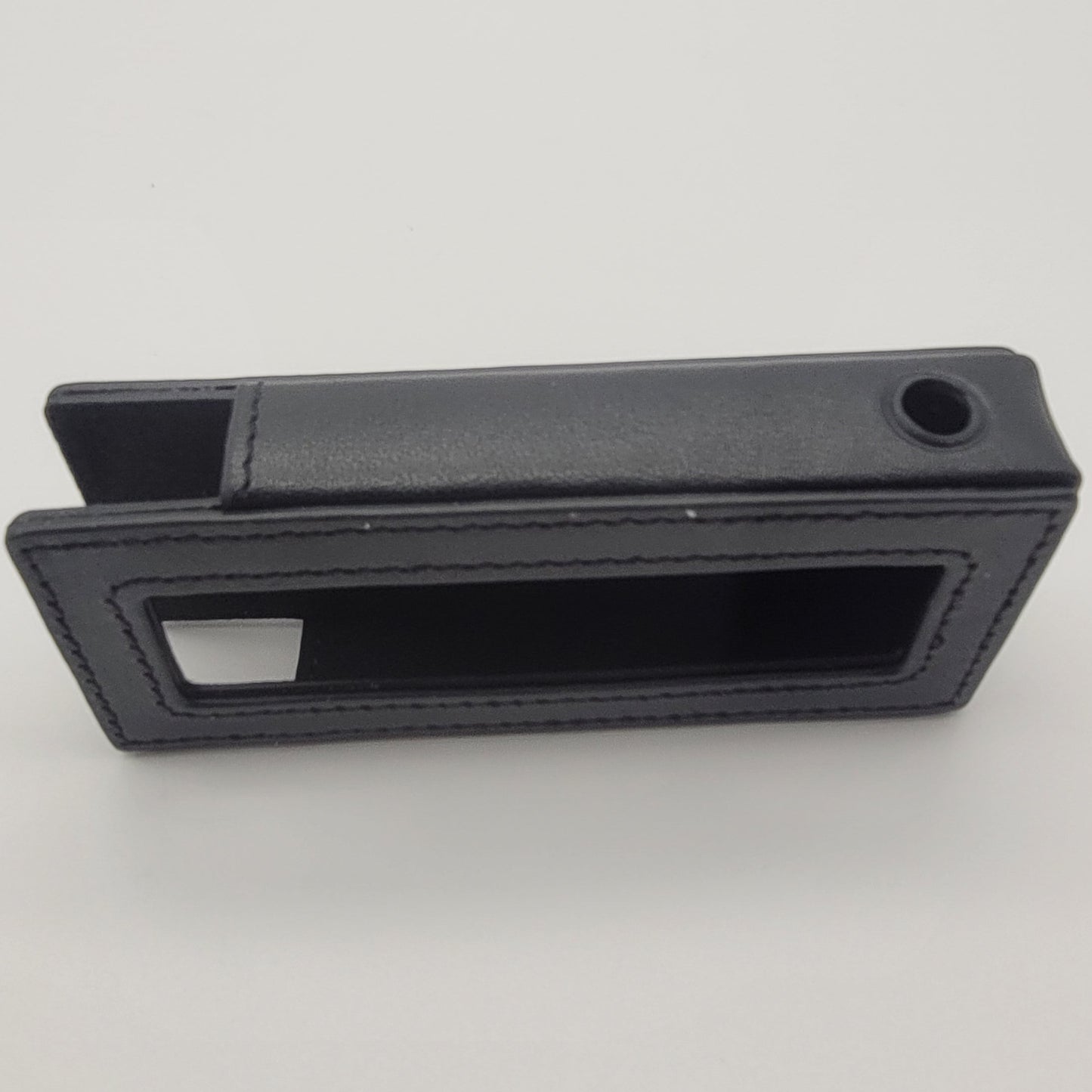 Black rectangular object with a slot on a white background